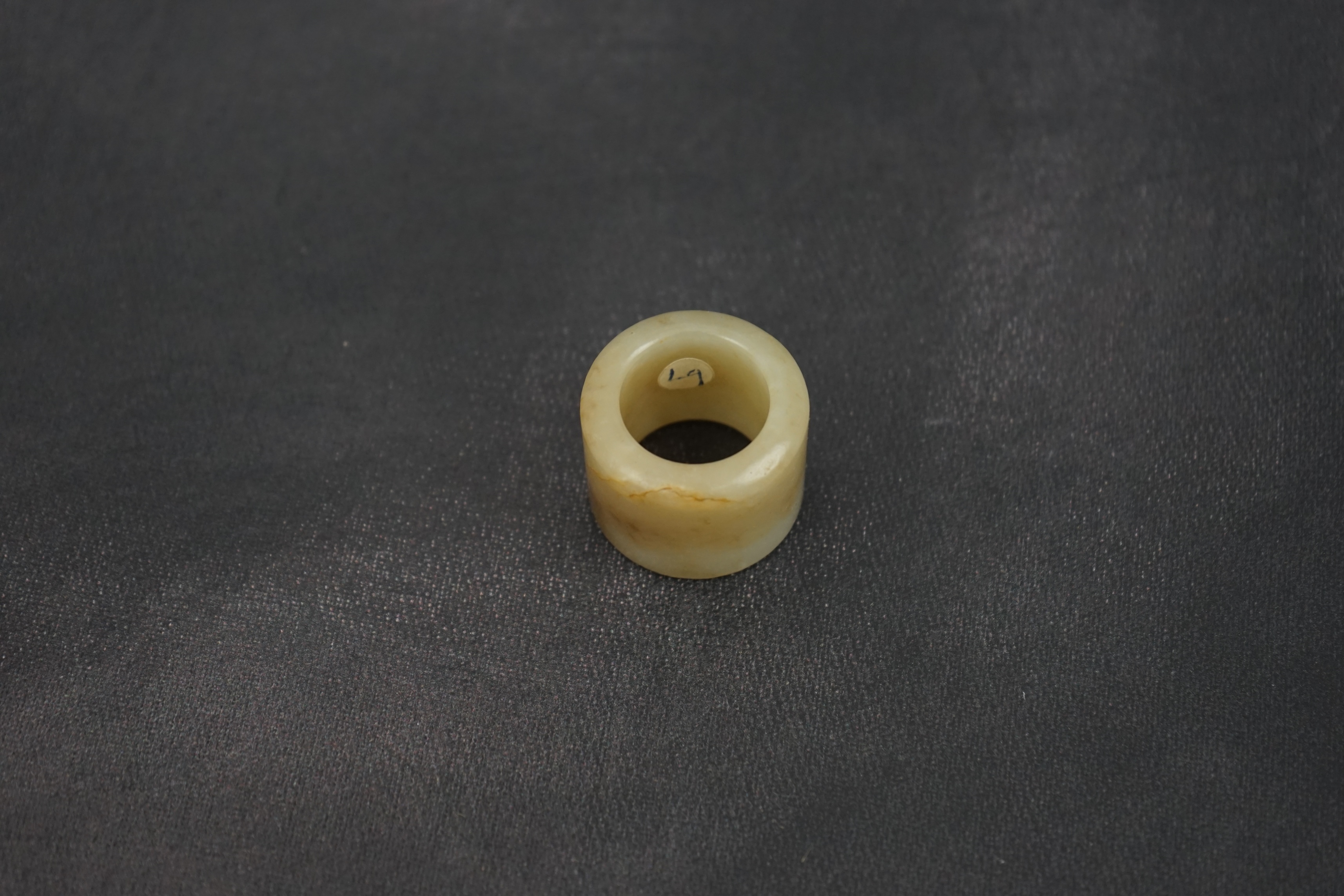 A Chinese pale celadon jade archer's thumb ring, 18th/19th century